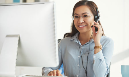 Smiling business lady working in call center